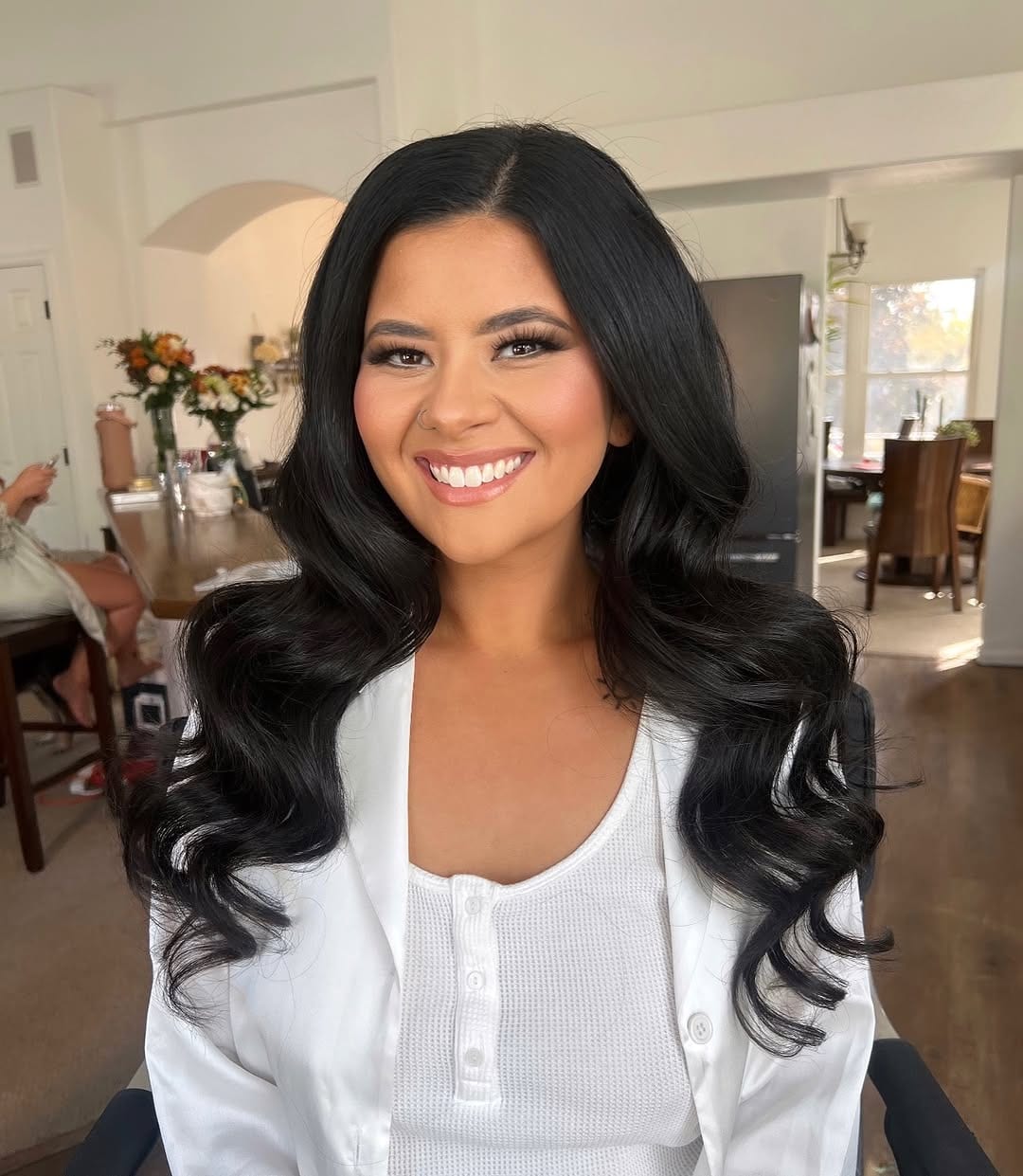 Bride with long dark waves in a white top