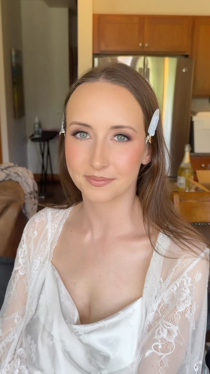 Bride with hair clips wearing a lace robe