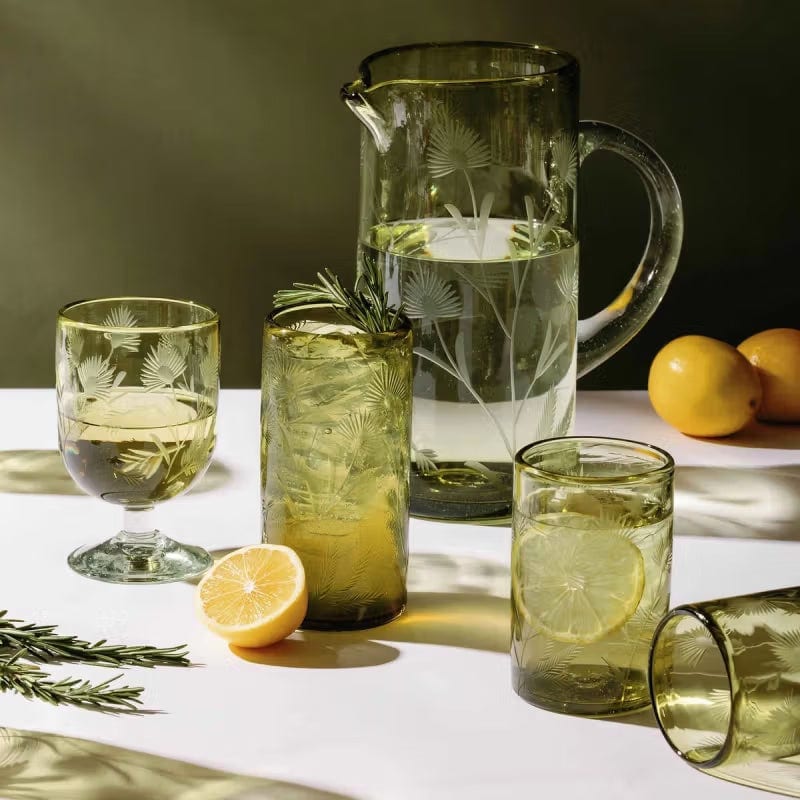 Green etched glass pitcher and tumblers with citrus and rosemary.
