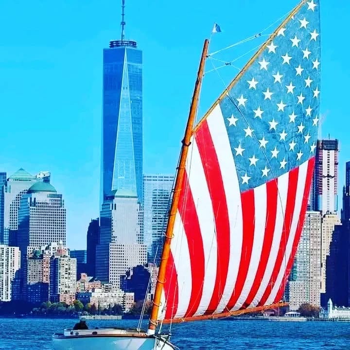 American flag on a sailboat before the Manhattan skyline